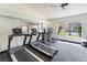 Community gym including treadmills, elliptical machines, and a scenic view at 221 Mission Catalina Ln # 104, Las Vegas, NV 89107