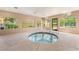 Indoor hot tub area with large windows offering views of greenery and the neighborhood at 221 Mission Catalina Ln # 104, Las Vegas, NV 89107