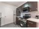 Well-lit kitchen showcasing stainless steel appliances, white countertops, and dark cabinets at 221 Mission Catalina Ln # 104, Las Vegas, NV 89107