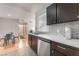 Modern kitchen featuring dark cabinets, stainless steel appliances, and an adjacent dining area at 221 Mission Catalina Ln # 104, Las Vegas, NV 89107