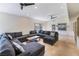 Expansive living room with a large sectional sofa, ceiling fans and windows at 221 Mission Catalina Ln # 104, Las Vegas, NV 89107