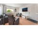 Comfortable living room area with a sofa, recliner, wood floors, balcony and mounted TV at 221 Mission Catalina Ln # 104, Las Vegas, NV 89107