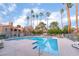 A refreshing swimming pool surrounded by lounge chairs and lush landscaping at 221 Mission Catalina Ln # 104, Las Vegas, NV 89107
