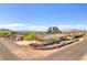 Charming single-story home featuring desert landscaping and mountain views against a clear blue sky at 2251 Thoroughbred Rd, Henderson, NV 89002