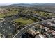 Expansive aerial view of the community highlighting homes, a golf course, and recreational areas at 2728 Faiss Dr, Las Vegas, NV 89134