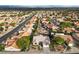 Wide aerial view of neighborhood and house with desert landscaping and tile roofs at 2728 Faiss Dr, Las Vegas, NV 89134