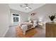 Bedroom featuring a ceiling fan, a decorative window, and a neutral color scheme at 2728 Faiss Dr, Las Vegas, NV 89134