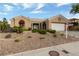 Charming single-story home featuring desert landscaping, a two-car garage, and a tile roof at 2728 Faiss Dr, Las Vegas, NV 89134