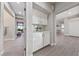 Hallway features a built-in cabinet with mirrored backsplash, plants, and hardwood flooring at 2728 Faiss Dr, Las Vegas, NV 89134