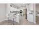 Modern kitchen with white cabinetry, stainless steel appliances, and breakfast bar seating at 2728 Faiss Dr, Las Vegas, NV 89134