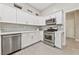 Modern kitchen with stainless steel appliances, subway tile backsplash and white cabinets at 2728 Faiss Dr, Las Vegas, NV 89134