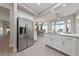 Open kitchen view featuring a stainless steel refrigerator and an adjacent dining area with bright lighting at 2728 Faiss Dr, Las Vegas, NV 89134