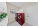 Laundry room features a modern washer and dryer set, plenty of cabinet space, and natural light at 2728 Faiss Dr, Las Vegas, NV 89134