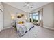 Bright, spacious main bedroom featuring neutral tones, a ceiling fan, and a picturesque bay window at 2728 Faiss Dr, Las Vegas, NV 89134