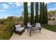 Outdoor patio with comfortable seating area, surrounded by tall trees and lush landscaping at 2728 Faiss Dr, Las Vegas, NV 89134