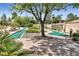 Beautiful putting green area with mature landscaping and tree cover at 2728 Faiss Dr, Las Vegas, NV 89134