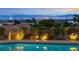 Breathtaking city views from the edge of the pool, framed by lush landscaping and thoughtful lighting at 2728 Faiss Dr, Las Vegas, NV 89134