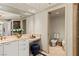 Bright bathroom featuring tiled floors, vanity, toilet room, and glass shower with marble walls at 2877 Paradise Rd # 2502, Las Vegas, NV 89109