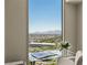 The clear glass desk top in front of this home's window offers a fabulous view of the city and mountains at 2877 Paradise Rd # 2502, Las Vegas, NV 89109
