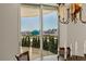 Chandelier-lit dining area features stunning views of the city skyline through large sliding glass doors at 2877 Paradise Rd # 2502, Las Vegas, NV 89109