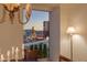 A chandelier hangs over a dining table with city views out of the floor to ceiling window at 2877 Paradise Rd # 2502, Las Vegas, NV 89109