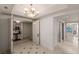 Well-lit hallway features tile floors, elegant chandelier, and access to other rooms at 2877 Paradise Rd # 2502, Las Vegas, NV 89109