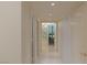 A clean, brightly lit hallway leads to a bedroom with a stunning city view at 2877 Paradise Rd # 2502, Las Vegas, NV 89109