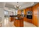 Bright kitchen with island, stainless appliances, wood cabinets, and floor-to-ceiling windows with city views at 2877 Paradise Rd # 2502, Las Vegas, NV 89109