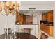 Modern kitchen featuring wood cabinetry, a breakfast bar, and a view of the dining area at 2877 Paradise Rd # 2502, Las Vegas, NV 89109