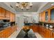 Gourmet kitchen with wooden cabinetry, granite countertops, large island, and stunning city views at 2877 Paradise Rd # 2502, Las Vegas, NV 89109