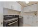 Well-equipped laundry room with front load washer and dryer and ample storage cabinets above at 2877 Paradise Rd # 2502, Las Vegas, NV 89109