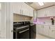 Modern laundry room with washer, dryer, sink, and ample cabinet space at 2877 Paradise Rd # 2502, Las Vegas, NV 89109