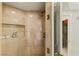 Shower featuring marble tile, brass fixtures, shelving, and a framed glass door at 2877 Paradise Rd # 2502, Las Vegas, NV 89109