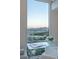 Desk area with glass top faces large window to showcase the expansive city and mountain views at 2877 Paradise Rd # 2502, Las Vegas, NV 89109