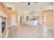 Spacious living room with fireplace and adjacent, bright kitchen with stainless appliances and granite countertops at 2889 Anteres St, Las Vegas, NV 89117