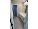 Bright bathroom features a single sink vanity, large mirror and wood-look tile flooring at 3339 Cromford Dr, North Las Vegas, NV 89081