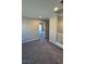 Inviting carpeted bonus area featuring a bright, open space with hallway access and plenty of natural light at 3339 Cromford Dr, North Las Vegas, NV 89081