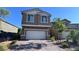 Two story home featuring a two car garage and paved driveway at 3339 Cromford Dr, North Las Vegas, NV 89081