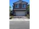 Two story home featuring a two car garage and a brick paved driveway at 3339 Cromford Dr, North Las Vegas, NV 89081