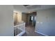 Upstairs hallway featuring carpet, white railing, and doorways to rooms, illuminated by recessed lighting at 3339 Cromford Dr, North Las Vegas, NV 89081