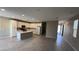 Bright, open kitchen with white cabinets, an island, and wood-look tile flooring at 3339 Cromford Dr, North Las Vegas, NV 89081