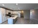 Modern kitchen with stainless appliances, white cabinetry, and island countertop at 3339 Cromford Dr, North Las Vegas, NV 89081