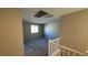 Neutral walls meet carpeted floors on the upstairs landing with white banister at 3339 Cromford Dr, North Las Vegas, NV 89081