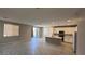 Open-concept living room with tile flooring and modern kitchen at 3339 Cromford Dr, North Las Vegas, NV 89081