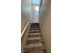 Carpeted staircase features a white handrail leading to the upper level at 3339 Cromford Dr, North Las Vegas, NV 89081