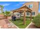 Outdoor haven featuring a charming gazebo perfect for relaxation and backyard entertaining with ample greenery at 4212 Hawks Glide Ave, North Las Vegas, NV 89084
