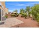 This spacious backyard features a gazebo with a picnic table, a grill, desert landscaping and shrubs at 4212 Hawks Glide Ave, North Las Vegas, NV 89084