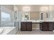 Bright bathroom features a double vanity, a glass shower, and a soaking tub for a luxurious bathing experience at 4212 Hawks Glide Ave, North Las Vegas, NV 89084