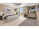 Serene primary bedroom boasts a balcony, ceiling fan, and stylish furnishings at 4212 Hawks Glide Ave, North Las Vegas, NV 89084