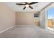 Bright bedroom featuring a ceiling fan and sliding door access to the balcony at 4212 Hawks Glide Ave, North Las Vegas, NV 89084